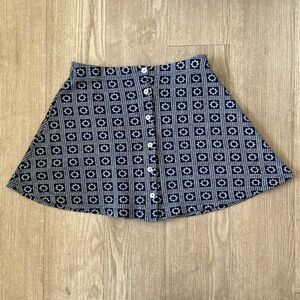 Navy floral print skirt that buttons up in the front.